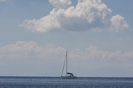 Lonely sailboat sails slowly expecting better windの写真素材