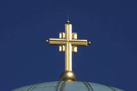 Golden cross on the top of templeの写真素材