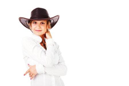 Portrait of a adorable young girl in cowboy hat on white backgroundの写真素材