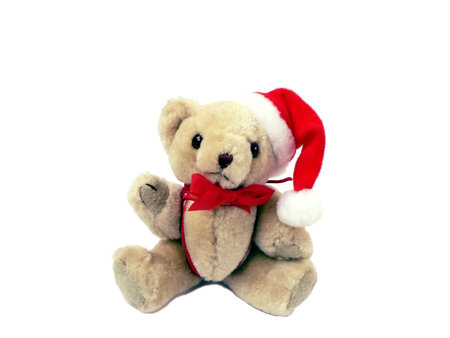 photo of a stuffed christmas bear tree ornament wearing a santa hat isolated on a white backgroundの写真素材