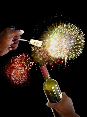 hand holding a cork screw just pulled from a bottle of wine to celebrate new years eve with...