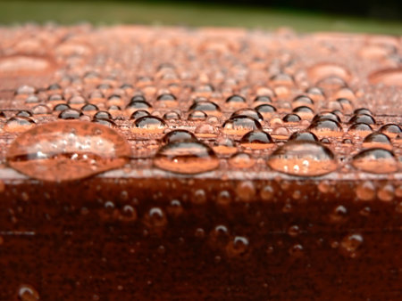 photo of raindrops beading on a water proofed deckの写真素材