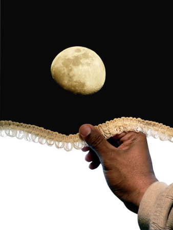 concept photo of daytime turning to nighttime depicting hand pulling down a moonlight sky shade to shut out the day.の写真素材