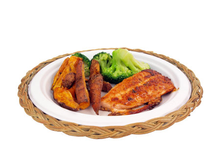 a dinner of salmon, sweet potato fries and brocolli isolated on white backgroundの写真素材