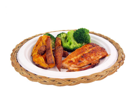 a dinner of salmon, sweet potato fries and brocolli isolated on white backgroundの写真素材