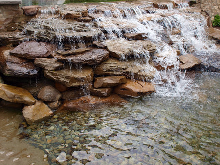 a landscaped waterfall made of stacked rocksの写真素材