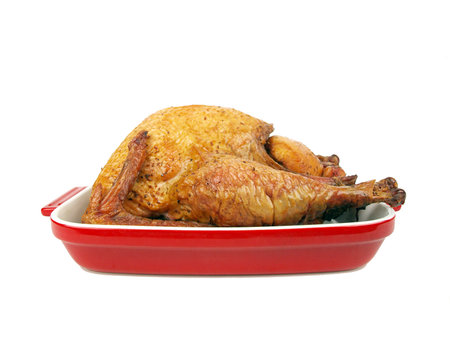 a cooked whole smoked turkey in a ceramic trayの写真素材