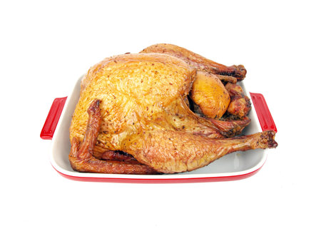 a cooked whole smoked turkey in a ceramic trayの写真素材