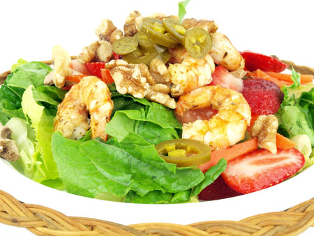 healthy salad of shrimp, lettuce, tomato. onion, pepper, walnuts and jalapeno on a white backgroundの写真素材