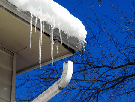 photo of damaged gutter on a home due to ice damming in itの写真素材