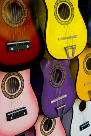 many different colored acoustic guitars arranged in patternの写真素材