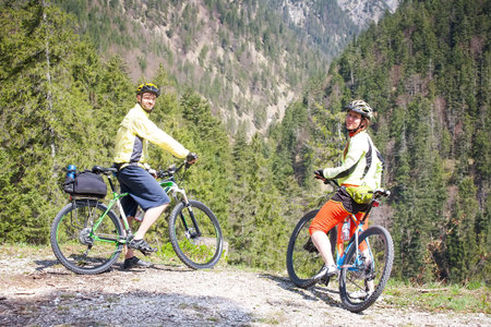 friends on a bike ride in the woodsの写真素材