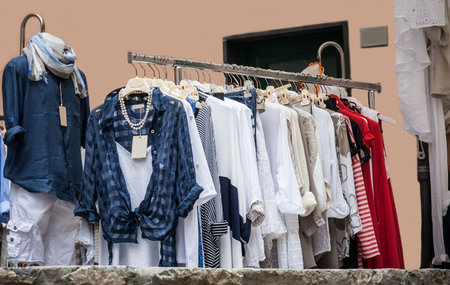 Close up details of colorful clothing on street market stallの写真素材