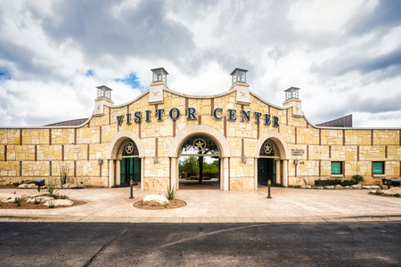 The San Angelo Visitor Center stands tall in the bustling Texas city, its entrance framed by a cloud-filled sky.の写真素材