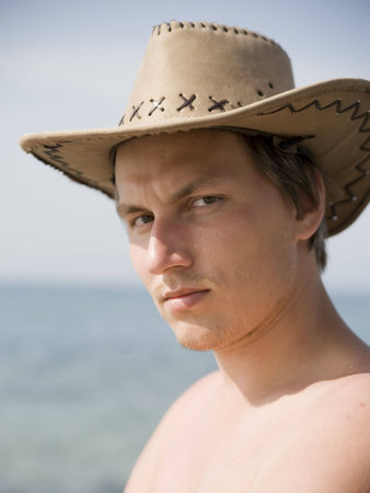 portrait of cowboy with brown hatの写真素材