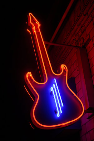red neon guitar with blue stringsの写真素材