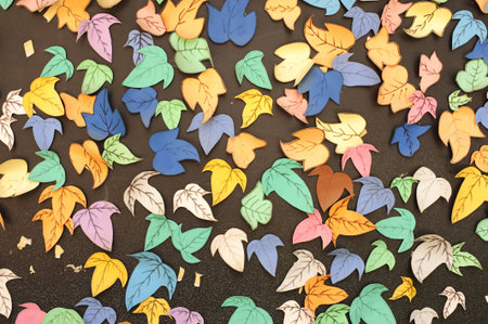 paper leafes made by childrens on the blackboardの写真素材