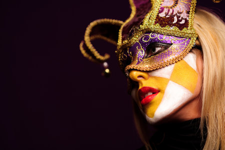 closeup portrait of sexy woman in violet party mask. good use for desire conceptの写真素材