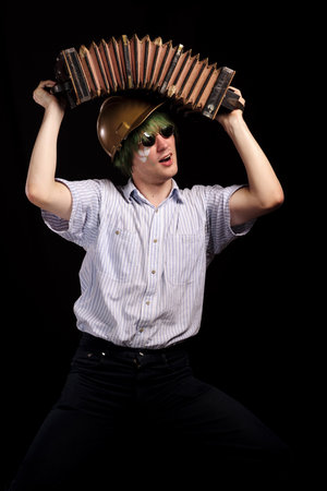 crazy harmonist made stun by accordion, isolated on black. may be use for safety engineering conceptの写真素材