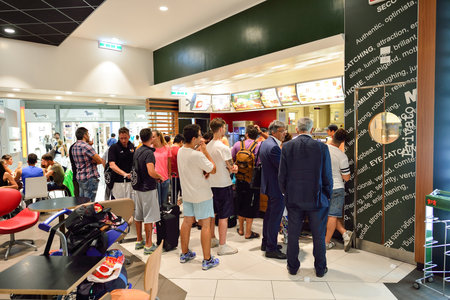 ROME, ITALY - AUGUST 04, 2015: people in McDonald's restaurant. The McDonald's Corporation is the...