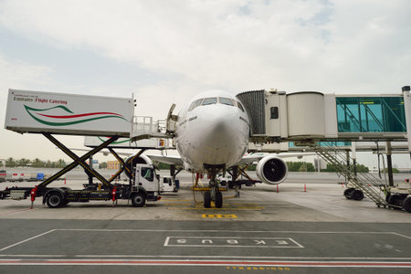 DUBAI, UAE - JUNE 23, 2015: Boeing 777-300ER docked in Dubai airport. Dubai International Airport is an international airport serving Dubai. It is a major airline hub in the Middle East, and is the main airport of Dubai.のeditorial素材