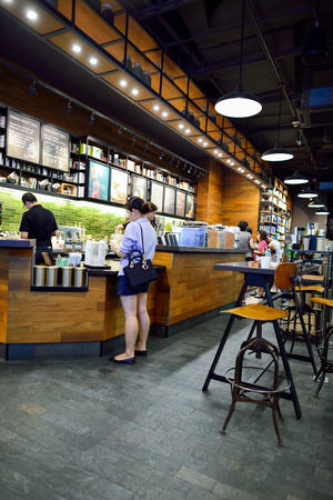 BANGKOK, THAILAND - JUNE 21, 2015: Starbucks Cafe interior. Starbucks Corporation is an American global coffee company and coffeehouse chain based in Seattle, Washingtonのeditorial素材
