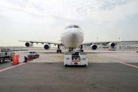 DUBAI, UAE - JUNE 23, 2015: Emirates Airbus A340-300 in Dubai airport. Dubai International Airport is an international airport serving Dubai. It is a major airline hub in the Middle East, and is the main airport of Dubai.のeditorial素材