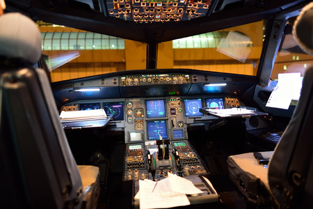 ROME, ITALY - AUGUST 04, 2015: Airbus A320 cockpit interior at night. The Airbus A320 family...
