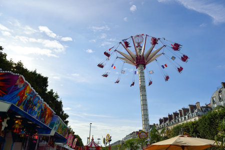 PARIS, FRANCE - AUGUST 09, 2015: amusement park near Louvre. Amusement parks evolved from European fairs and pleasure gardens, which were created for people's recreationのeditorial素材