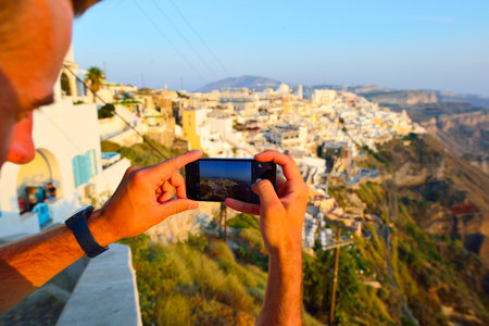 SANTORINI, GREECE - AUGUST 07, 2015: people meet sunset on Santorini island. Santorini, classically Thera, and officially Thira, is an island in the southern Aegean Seaのeditorial素材