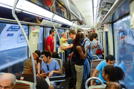 PARIS - AUGUST 10, 2015: people in Paris Metropolitain train. The Paris Metro or Metropolitain is a rapid transit system in the Paris Metropolitan Areaのeditorial素材