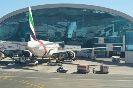 DUBAI, UAE - NOVEMBER 16, 2015: Boeing 777-300 docked in Dubai airport. Dubai International Airport is an international airport serving Dubai. It is a major airline hub in the Middle East, and is the main airport of Dubai.のeditorial素材