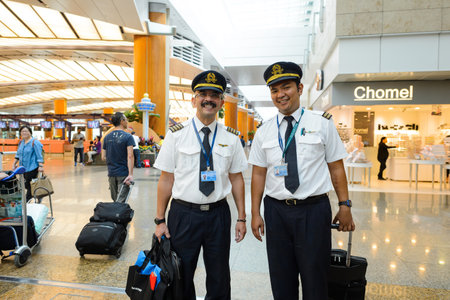 SINGAPORE - NOVEMBER 07, 2015: pilots at Changi Airport. Singapore Changi Airport, is the primary civilian airport for Singapore, and one of the largest transportation hubs in Southeast Asiaのeditorial素材