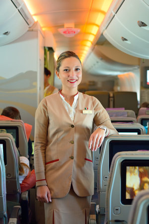 DUBAI - NOVEMBER 17, 2015: Emirates crew member on board of Airbus A380. Emirates is an airline...