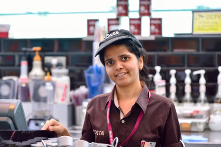 DUBAI, UAE - NOVEMBER 16, 2015: barista in Costa Coffee cafe in Dubai Airport. Dubai International Airport is the world's busiest airport by international passenger traffic.のeditorial素材