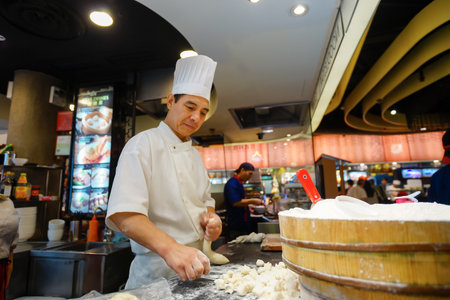 SINGAPORE - NOVEMBER 08, 2015: cook prepare food on the food court of The Shoppes at Marina Bay Sands. The Shoppes at Marina Bay Sands is one of Singapore's largest luxury shopping mallsのeditorial素材