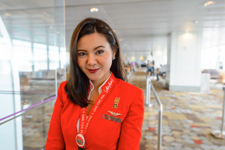 SINGAPORE - NOVEMBER 04, 2015: AirAsia crew member in Changi International Airport. AirAsia is a Malaysian low-cost airline headquartered near Kuala Lumpur, Malaysiaのeditorial素材