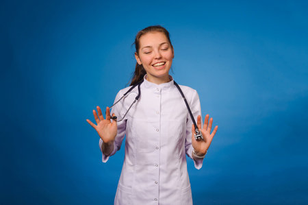 Studio portrait of young intern against blue backgoundの写真素材