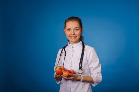 Studio portrait of young intern against blue backgoundの写真素材