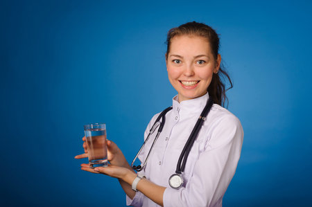 Studio portrait of young intern against blue backgoundの写真素材