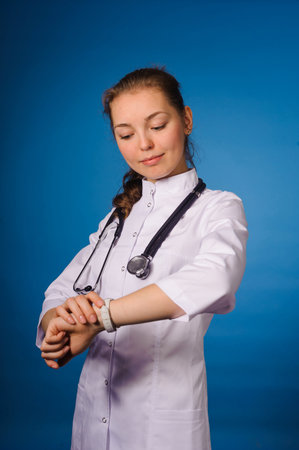 Studio portrait of young intern against blue backgoundの写真素材