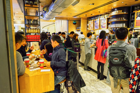 HONG KONG - DECEMBER 25, 2015: customers of Starbucks cafe. Starbucks Corporation is an American global coffee company and coffeehouse chain based in Seattle, Washingtonのeditorial素材