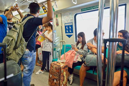 SINGAPORE - NOVEMBER 07, 2015: passengers in MRT train. The Mass Rapid Transit, or MRT, is a rapid transit system forming the major component of the railway system in Singapore, spanning the entire city-stateのeditorial素材