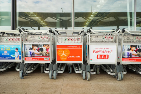 HONG KONG - DECEMBER 24, 2015: baggage trolleys near entrance to Hong Kong Airport. Hong Kong International Airport is the main airport in Hong Kong. It is located on the island of Chek Lap Kokのeditorial素材