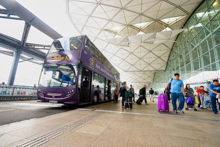 HONG KONG - DECEMBER 24, 2015: double-decker bus near Hong Kong Airport building. Hong Kong International Airport is the main airport in Hong Kong. It is located on the island of Chek Lap Kokのeditorial素材