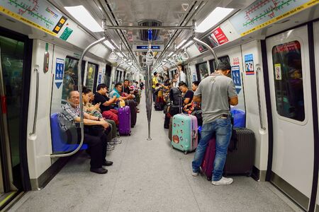 SINGAPORE - NOVEMBER 07, 2015: passengers in MRT train. The Mass Rapid Transit, or MRT, is a rapid transit system forming the major component of the railway system in Singapore, spanning the entire city-stateのeditorial素材
