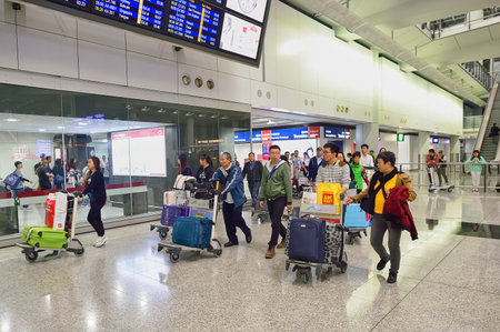 HONG KONG - NOVEMBER 15, 2015: passengers in Hong Kong Airport. Hong Kong International Airport is the main airport in Hong Kong.のeditorial素材