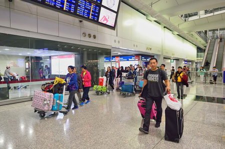 HONG KONG - NOVEMBER 15, 2015: passengers in Hong Kong Airport. Hong Kong International Airport is the main airport in Hong Kong.のeditorial素材