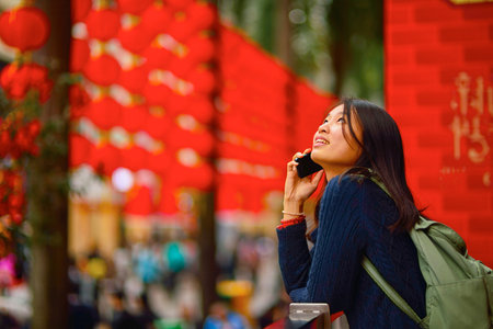 Chinese woman talking on cell phone during chinese new yearの写真素材