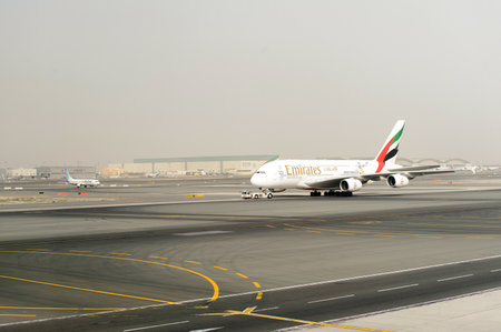 DUBAI, UAE - MARCH 10, 2015: jet aircraft in Dubai airport. Dubai International Airport is an...